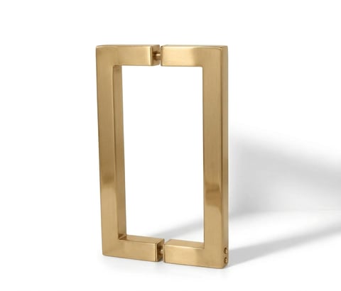 Gold rectangular door handle with a modern minimalist design and mounting brackets, isolated on white background
