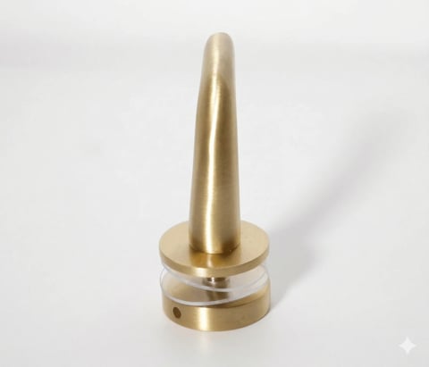 Polished brass cone-shaped object with cylindrical base on white background