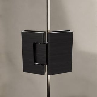 Black glass shower door hinge and handle mounted on a metal pole against a beige wall