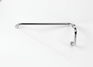 Chrome towel bar mounted on white wall with horizontal bar and angled supports