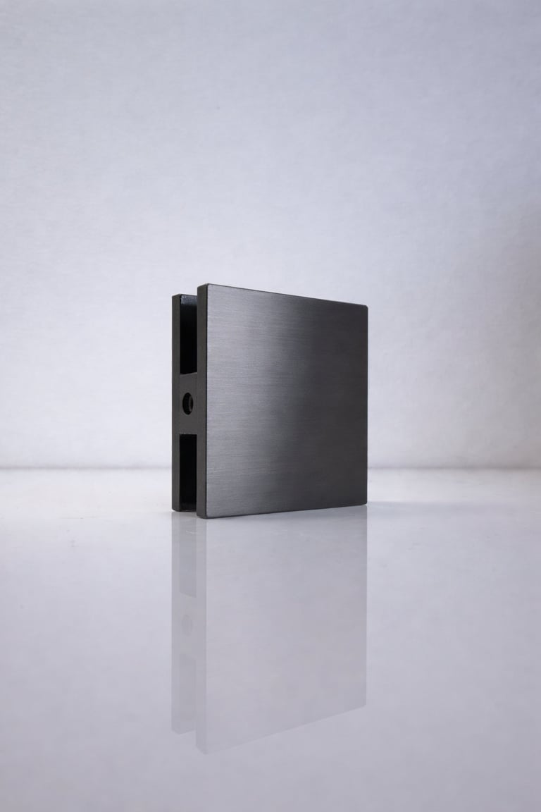 Black brushed metal computer case standing upright on white surface with reflection, minimalist design against gray background