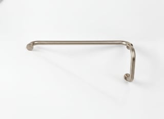 Stainless steel pull handle with rounded ends mounted on white background
