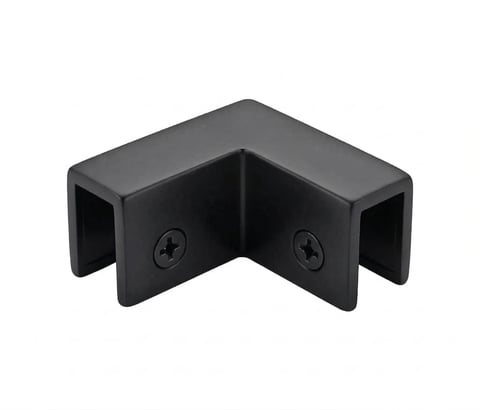 Black plastic corner bracket with two screw holes and hollow rectangular ends for joining materials at right angles