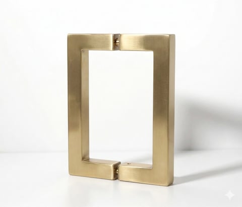 Gold-toned metal picture frame with rectangular shape and empty white center, displayed on white surface
