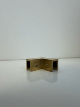 Brass-colored folded metal box with keyhole details